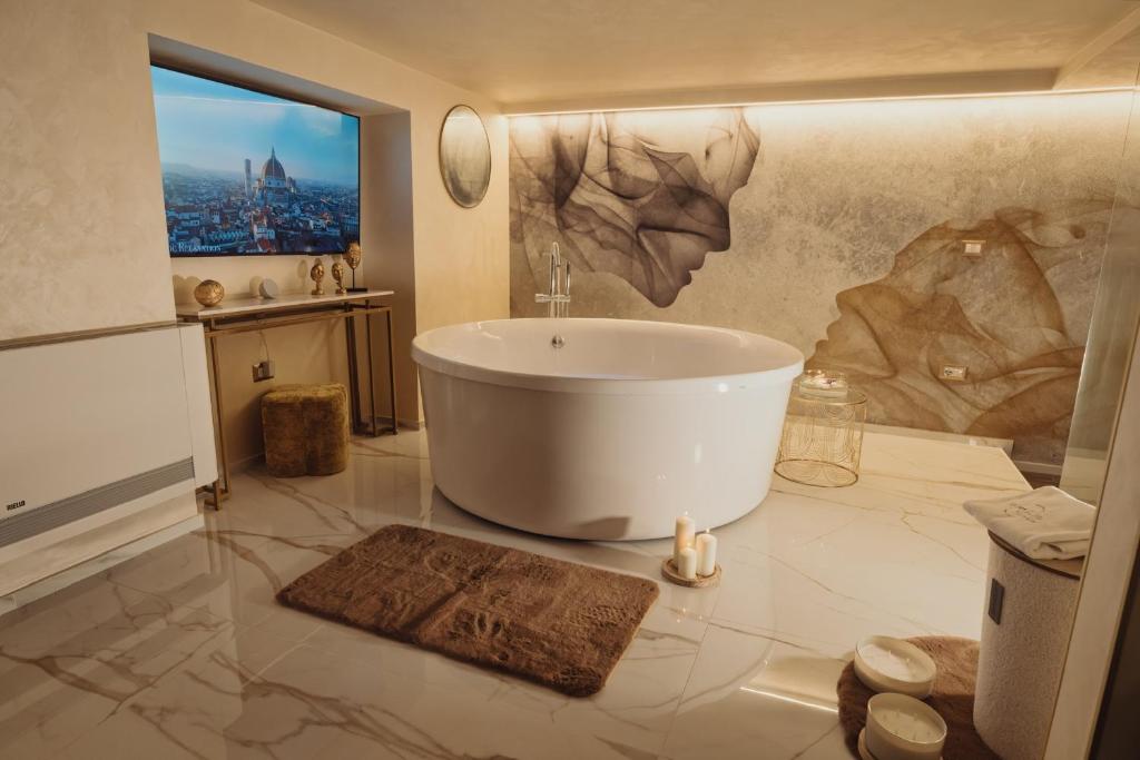 a bathroom with a large tub in a room at Golden Suite in Stornarella