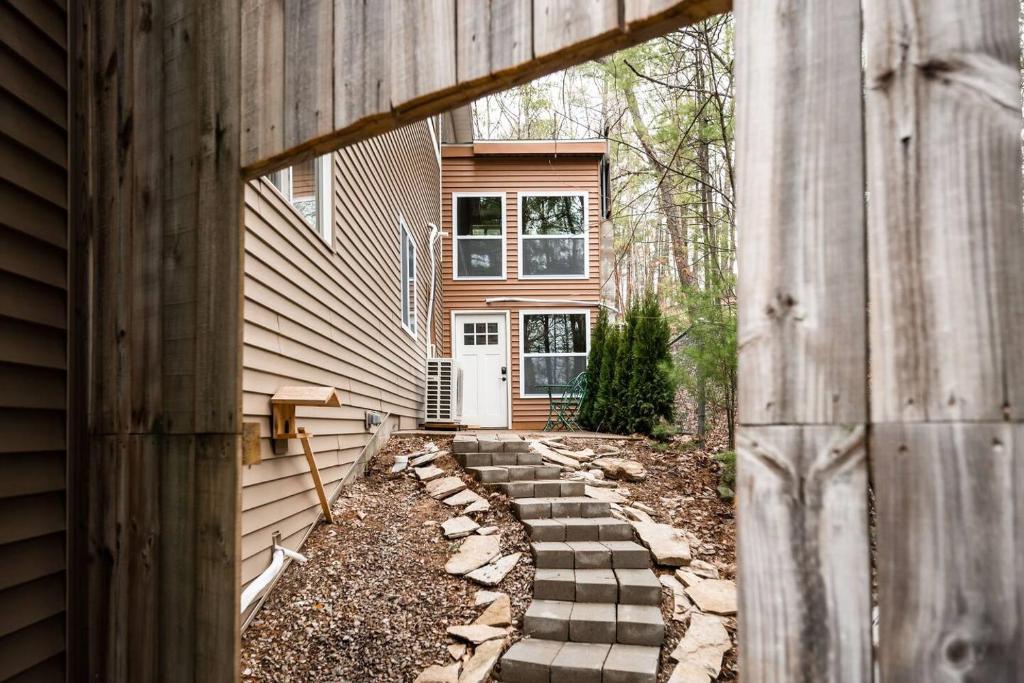 a house with a pathway leading to the front door at Tiny Loft-Spider Lake-SUP Rentals-Beach-10mi to TC in Traverse City
