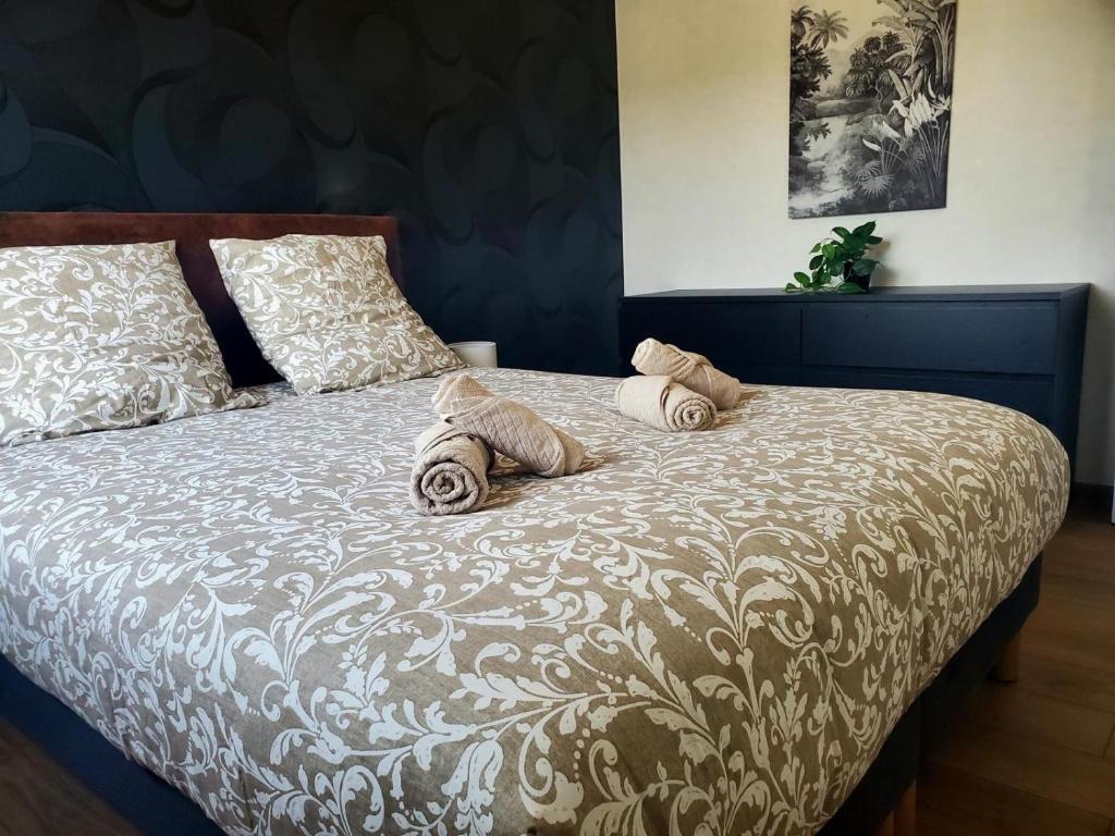 a bed with two pillows on top of it at Le Cocon Clermontois - T2 Centre in Clermont-Ferrand