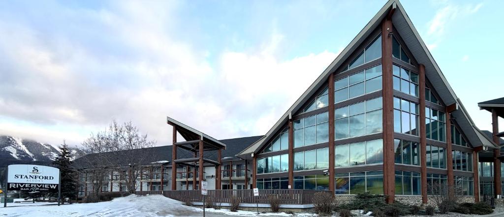 a large building with glass windows in the snow at Fernie Stanford Resort in Fernie