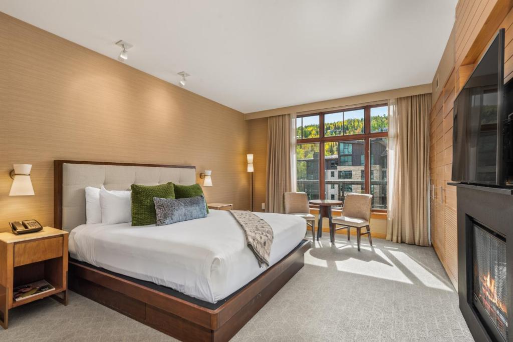 a hotel room with a bed and a fireplace at Ski-In Ski-Out Resort Studio Steps from Slopes in Snowmass Village