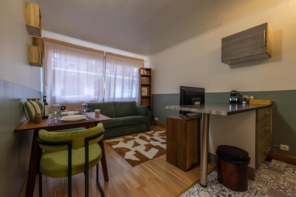 a small living room with a couch and a table at Studio plein centre in Aix-les-Bains