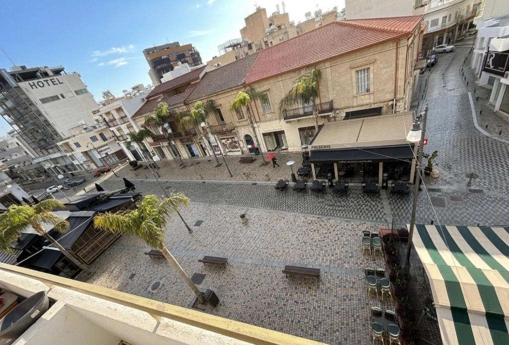 a view of a courtyard in a city with buildings at Lux Apartment City View in Larnaca