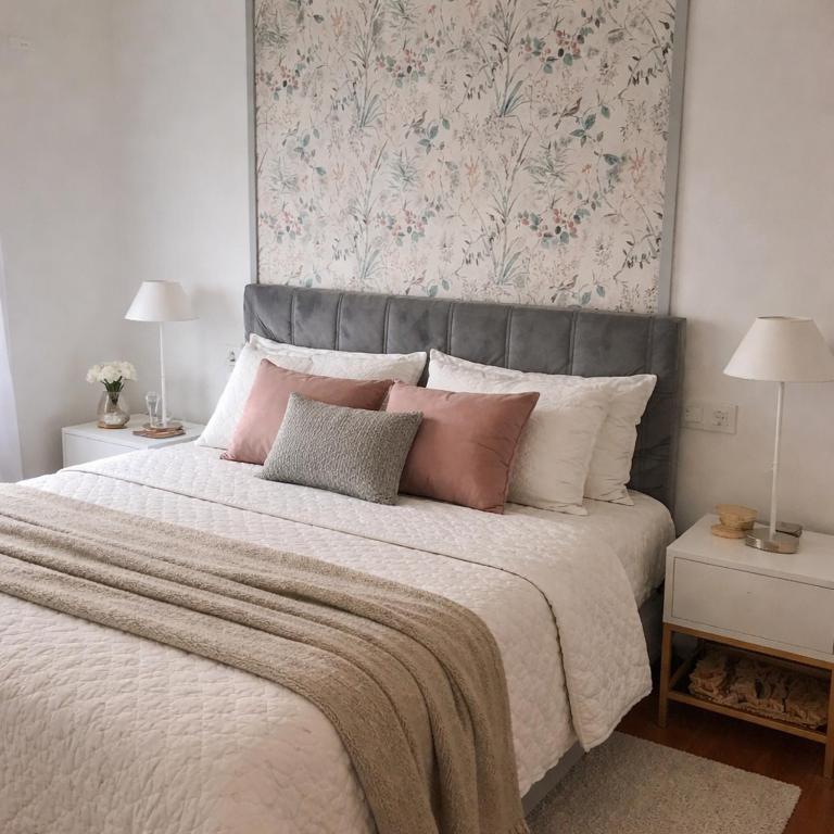a bedroom with a large bed with pink and white pillows at Apartamento Rural Borgia in Borja