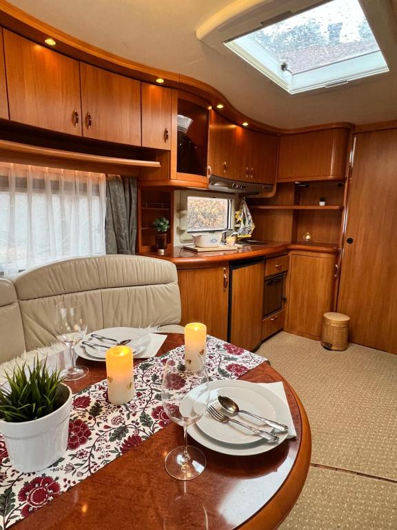 a dining room with a table in an rv at Nordic Dream Camper 1 in Syfteland