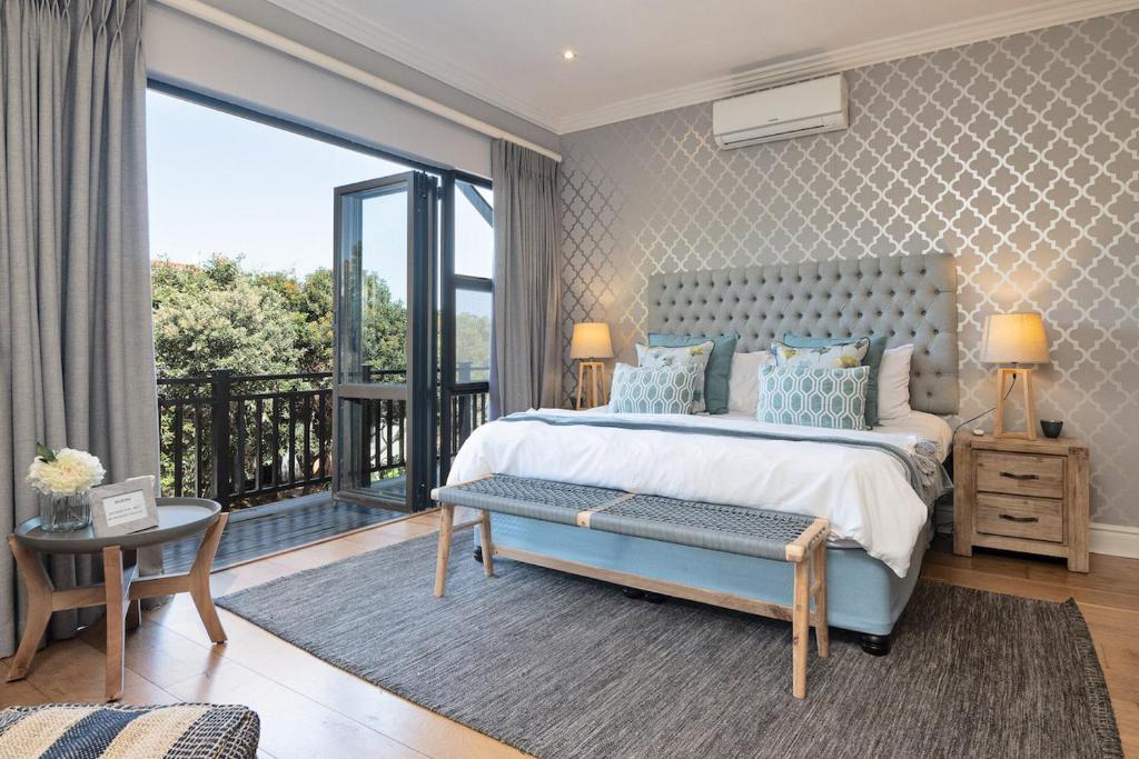 a bedroom with a large bed and a balcony at 11 Bonabali in Ballito