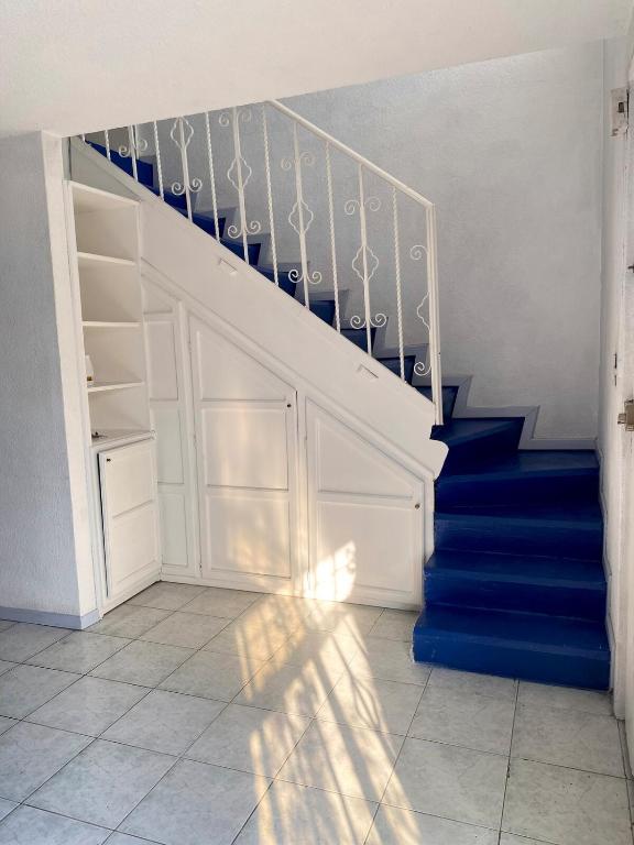 a staircase with blue stairs and a blue carpet at Cozy house in the Angelópolis area in La Concepción