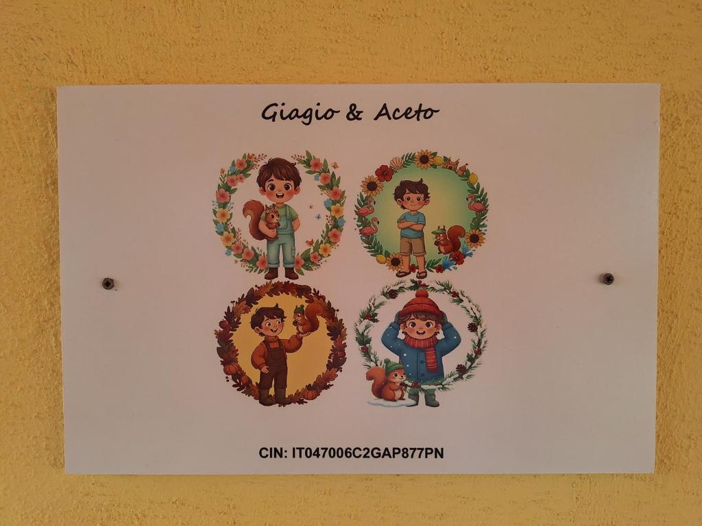 a sign with four children in wreaths on a wall at Giagio & Aceto in Larciano
