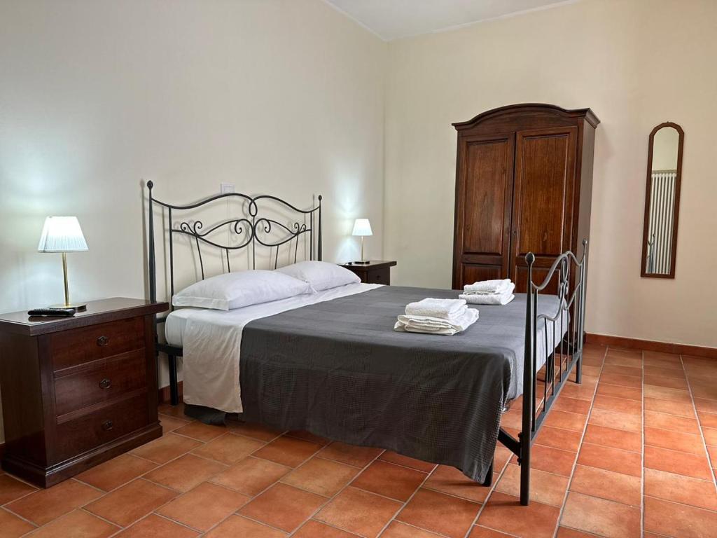 a bedroom with a bed and a wooden dresser at Locanda Del Castello Bed an Breakfast in San Panfilo dʼOcre