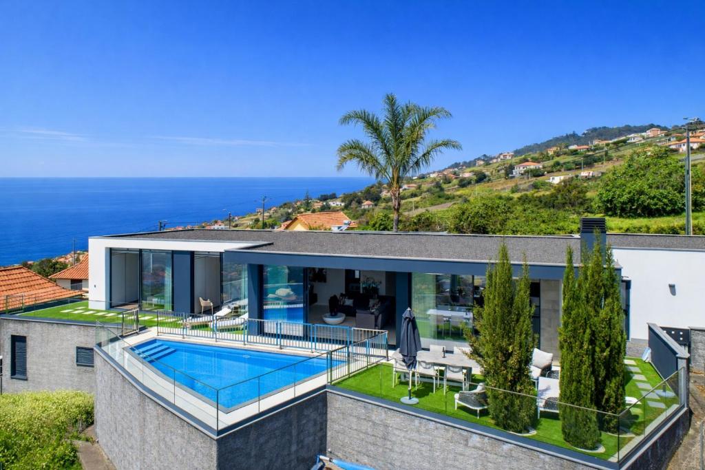 an image of a house with a swimming pool at Luxury Ocean View Villa I Swimming pool I Vincents Place in Estreito da Calheta