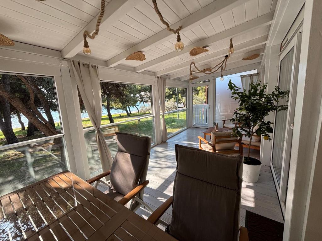 a screened in porch with a table and chairs at Dream Escape Mobile Home in Vodice