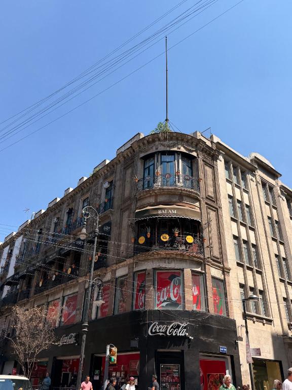 a tall building with people walking in front of it at Hotel Terracota mx in Mexico City
