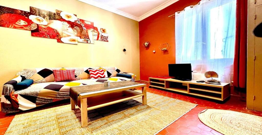 a living room with a couch and a tv at Brise Douce in Perpignan