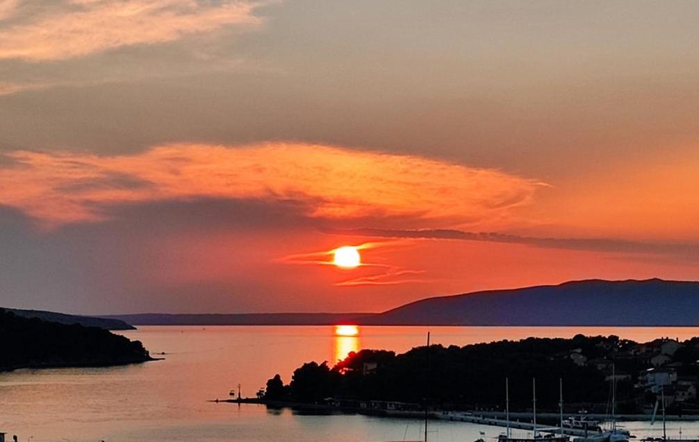 a sunset over a body of water with the sun setting at Cres Sea & Sunset View in Cres