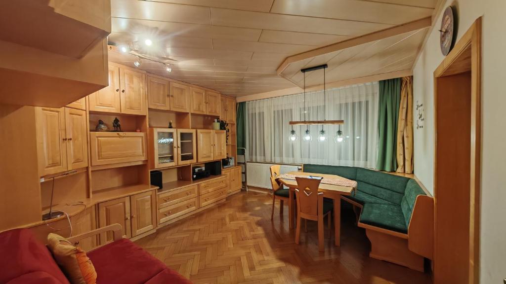 a kitchen with a green couch and a table at Vintage Apartment in Graz