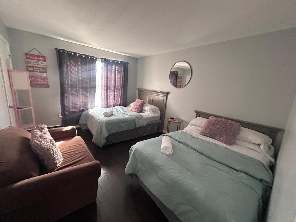 a living room with two beds and a couch at Kickback and relax in Elizabeth