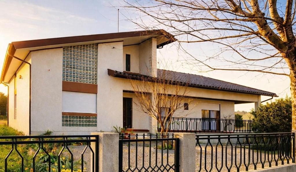 a house with a black fence in front of it at Casa da Tia in Poutena