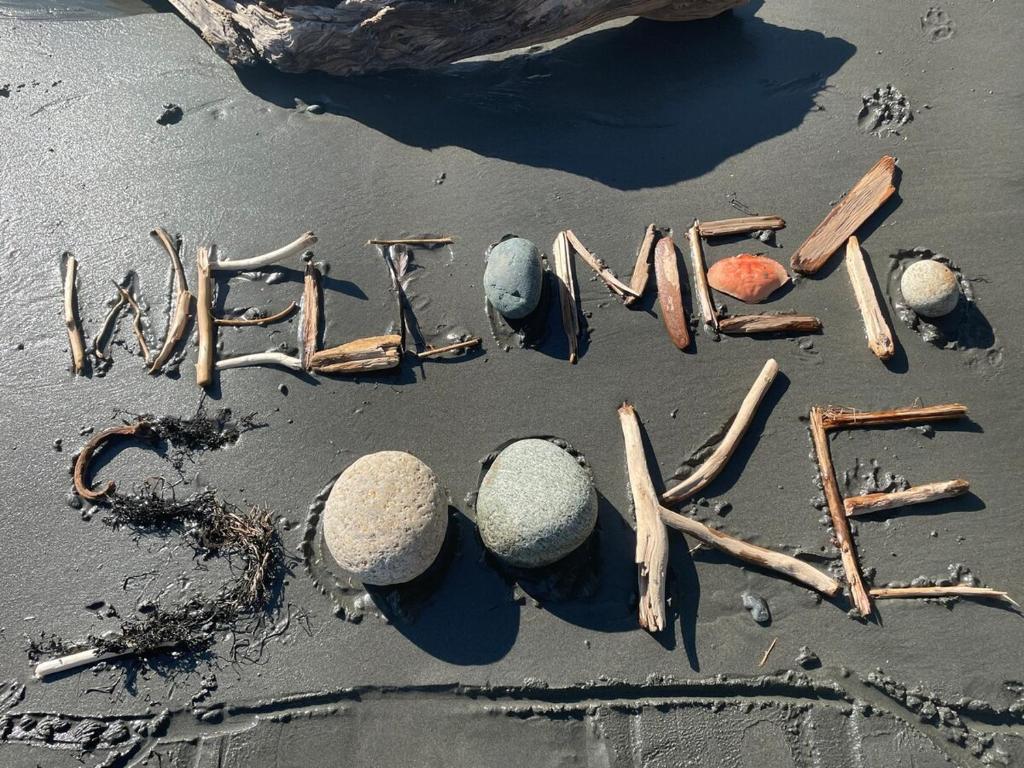 a word written in the sand on a beach at Stay and Spa in Sooke