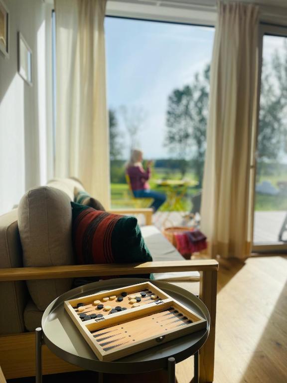 a living room with a chess board on a table at Skrzydła Biebrzy- Eco Cottage nad rzeką Narwią - Biebrza NP in Niwkowo