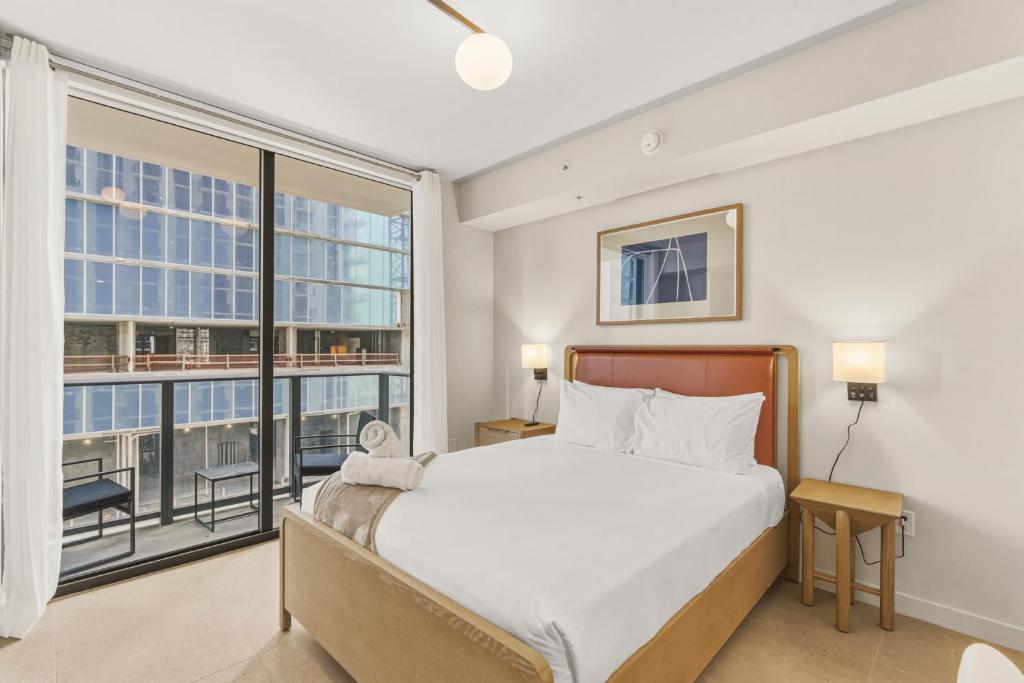 a bedroom with a bed and a large window at Luxury Studio Steps from Bayfrontpark in Miami