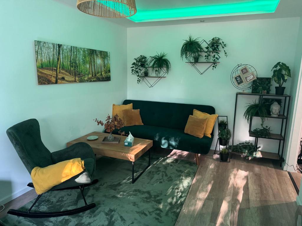 a living room with a green couch and a table at Buda Side Comfort in Budapest