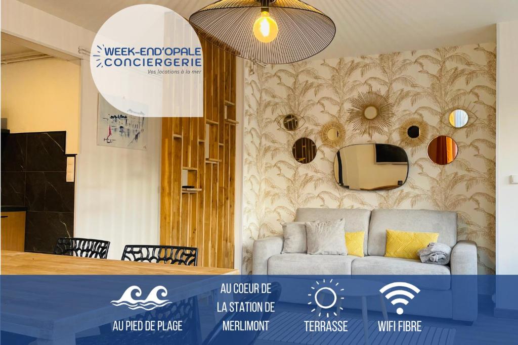 a living room with a couch in a room with a wall at Sunset centre Merlimont Plage in Merlimont
