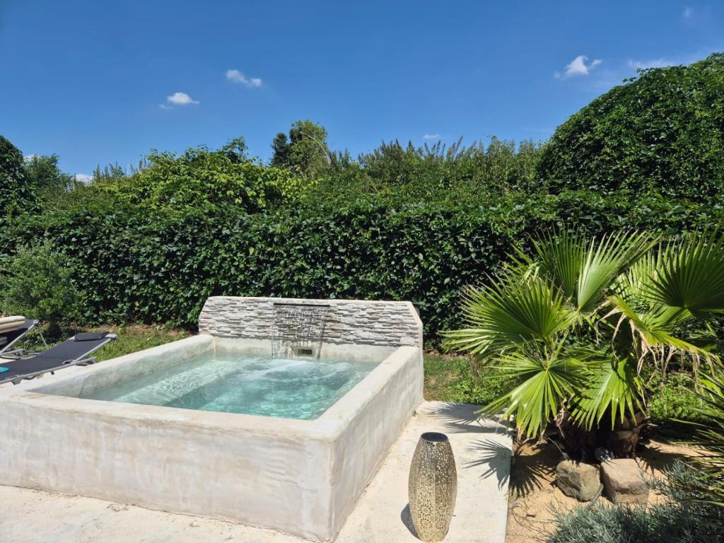 a large stone tub with a fountain in a yard at Residence Chateau d Eau in Mitry-Mory