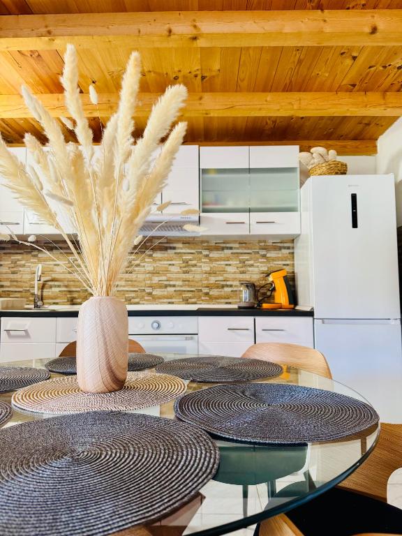 a kitchen with a table with a vase on it at Villa Silent Bay Lučice in Milna