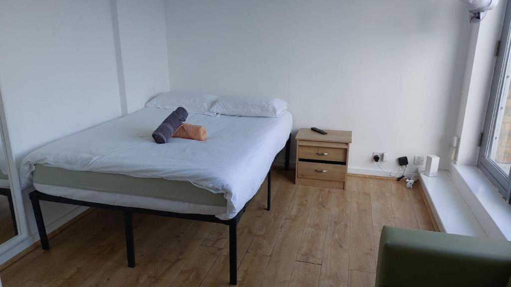 a small bedroom with a bed and a night stand at Newbury 2 in London