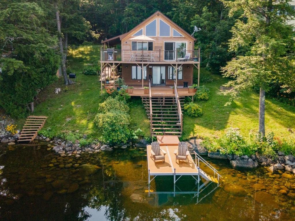 an aerial view of a house on the water at Red Cedar Haven Lakeside Tranquility in Sidney
