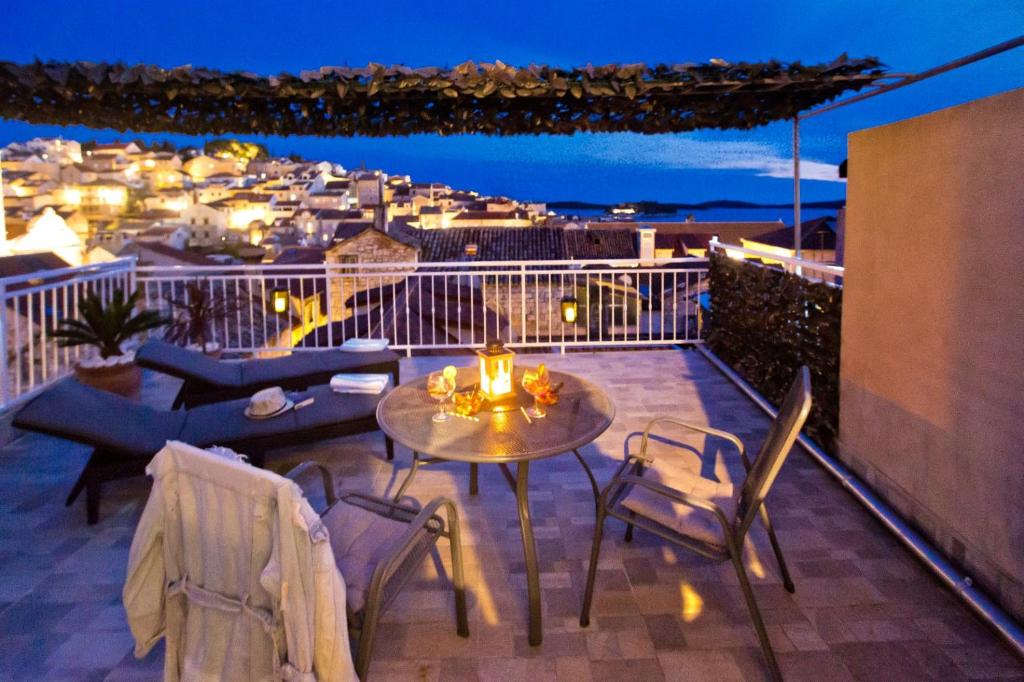 a patio with a table and chairs on a balcony at Core of Hvar Old Town in Hvar