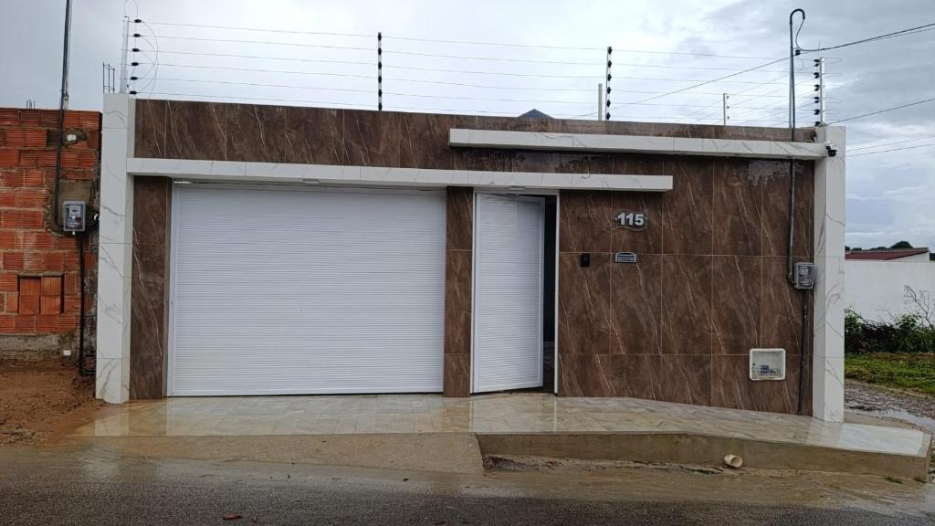 a pair of white garage doors on a building at SSP Ubajara in Ubajara