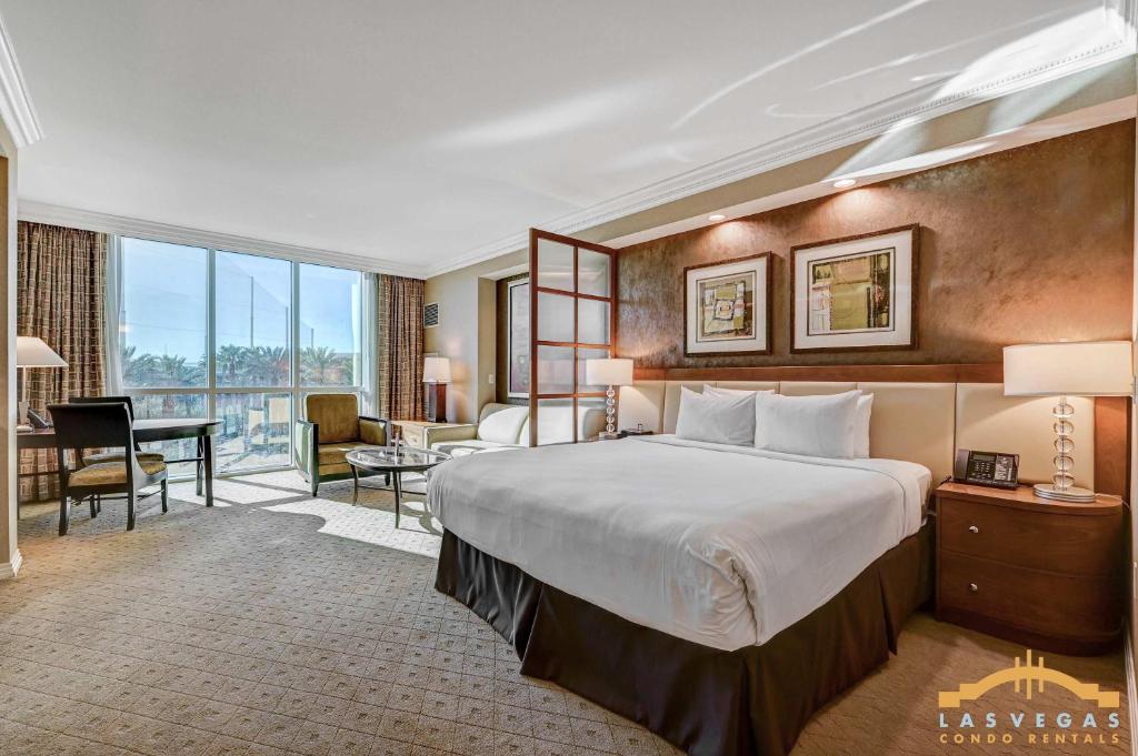 a hotel room with a large bed and a desk at MGM Signature 03-818 Jacuzzi Studio in Las Vegas