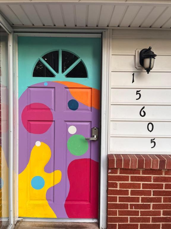 a door with a painting on the side of a house at Casa Pinturella in Silver Spring