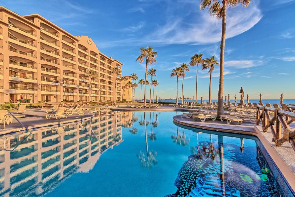 a resort with a pool and palm trees at Penthouse Beachfront at Sonoran Spa in Puerto Peñasco