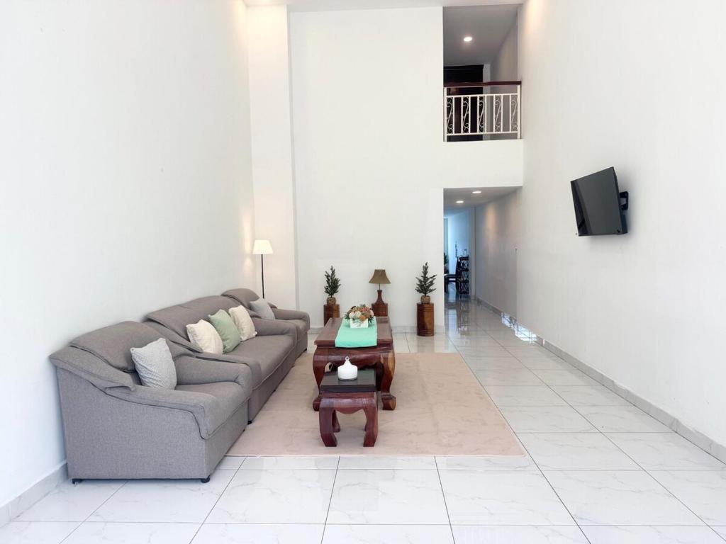 a living room with a couch and a table at Spacious 5BR Townhouse in Central Phnom Penh in Phnom Penh