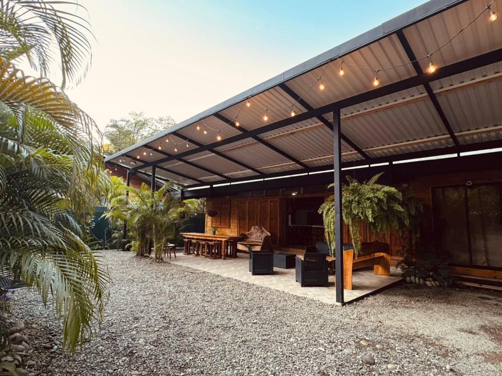 a building with awning with a table and a bench at Hotel Mauka Boutique Villas in Cocles