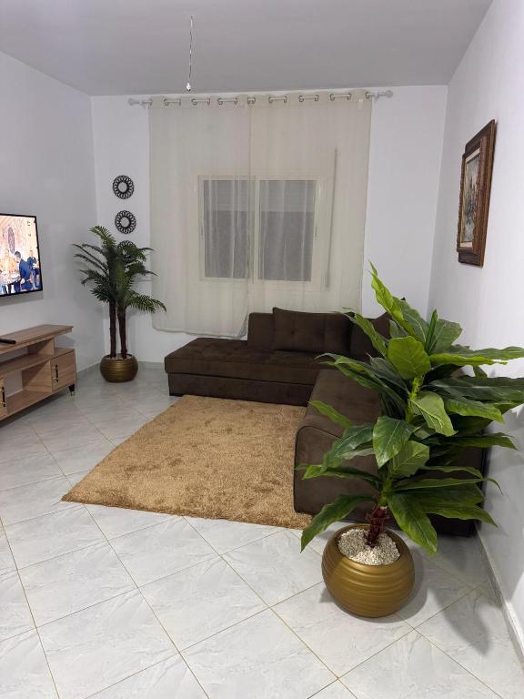 a living room with a couch and a rug at Le Nide d'azrou in Azrou