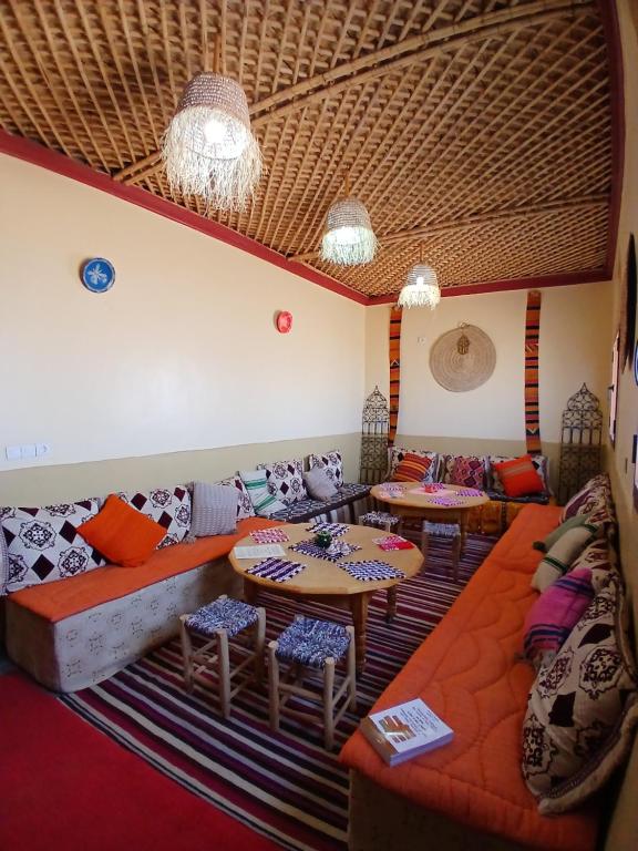 a living room with a couch and tables at Dar Bani in Zagora