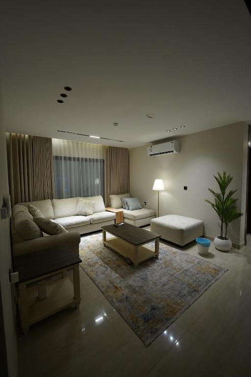 a living room with a couch and a table at Elite Alsultan in Al Khobar