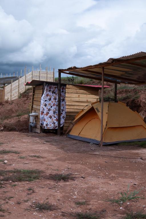 a building with a roof and a tent at Camping tres nevados in Urubamba