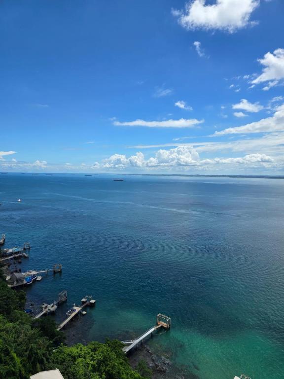 an aerial view of a body of water with boats at Vitória Marina Flats in Salvador