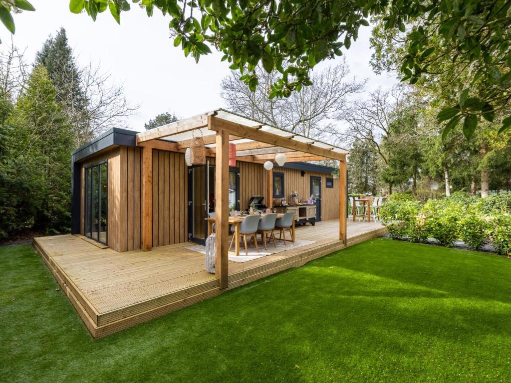 a house with a deck in a garden at Het Hertenpad in Hattemerbroek