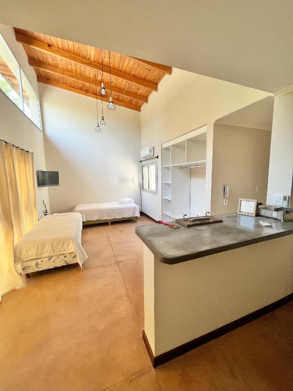 a large room with a kitchen with a bed in it at Monoambiente PIPE in Bella Vista