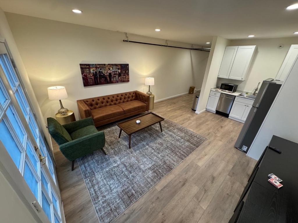a living room with a couch and a table at The Bourbon & Brass - Speakeasy-Inspired 2BDR in St. Charles