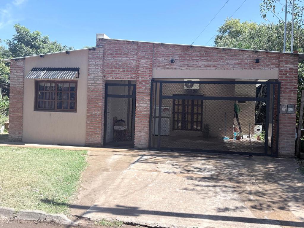a brick building with a door and a window at Casa saavedra in Estación Ramallo