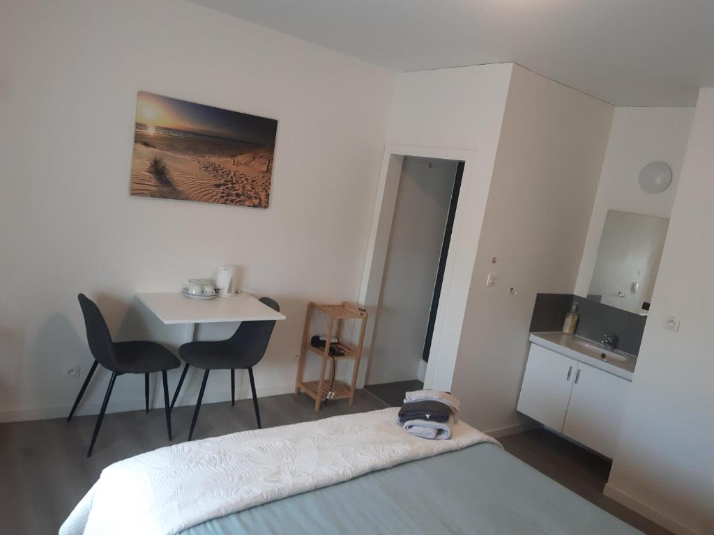 a bedroom with a bed and a sink and a table at B&B Casa Mama in Brugge in Bruges