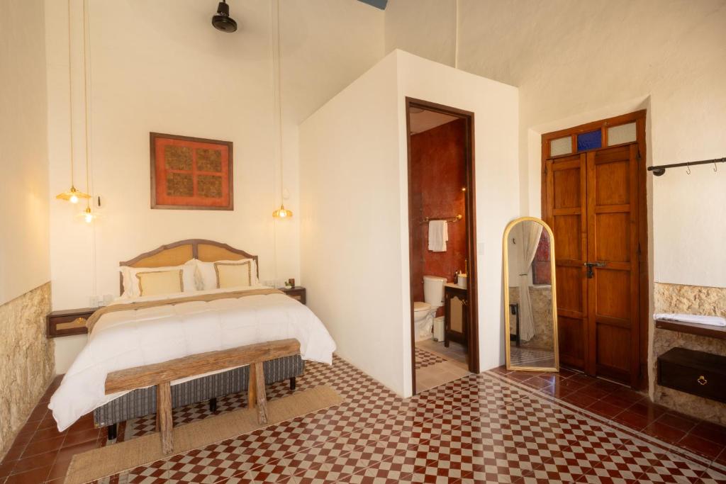 a bedroom with a bed and a bathroom at Dos Almas Casa Boutique in Campeche