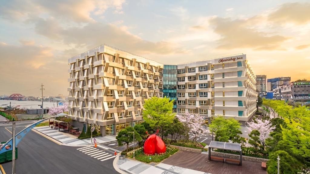 an apartment building with a red tent in a city at Marinabay Sokcho in Sokcho