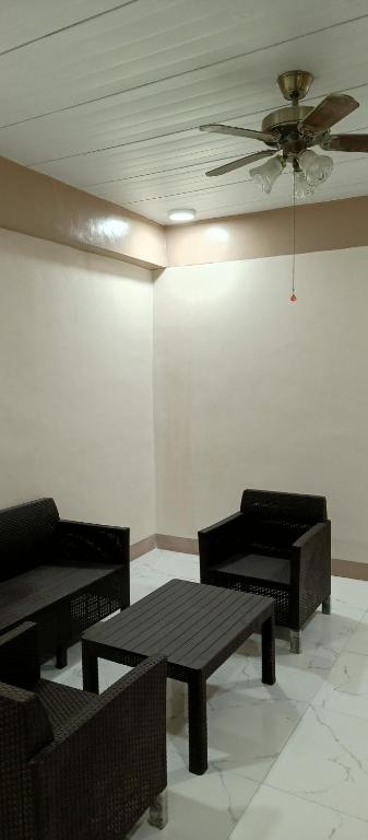 a room with tables and chairs and a ceiling at Melinda Place in Camarin